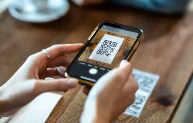 Cliente escaneando un código QR para abrir el menú digital